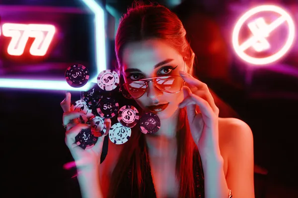 A glamorous woman holding casino chips in a neon-lit environment, representing the premium online casino atmosphere of SLO16.